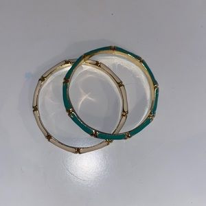 two gold accented white and aqua bracelets